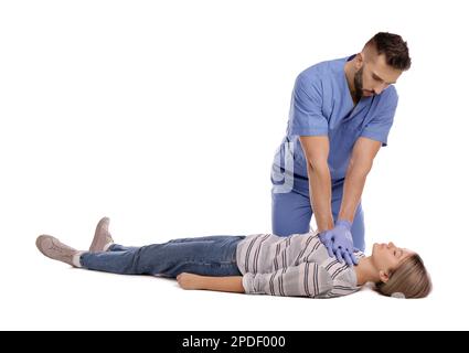 Doctor in uniform performing first aid on unconscious woman against white background Stock Photo