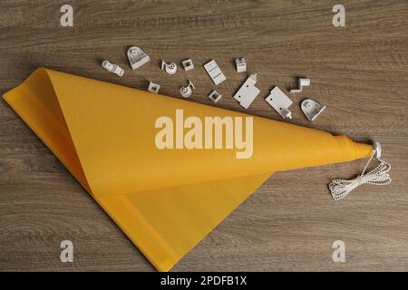 Stylish roller window blinds and details on wooden table, flat lay Stock Photo