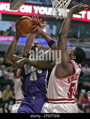 Houston Rockets' Tracy McGrady (1) dunks the ball as Chicago Bulls' Luol  Deng (9), of Sudan, and Chicago Bulls' Andres Nocioni (5), of Argentina,  watch during the first quarter of their NBA