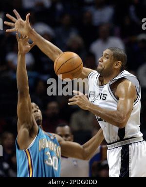 New Orleans Hornets' David West (30) fouls San Antonio Spurs Tim