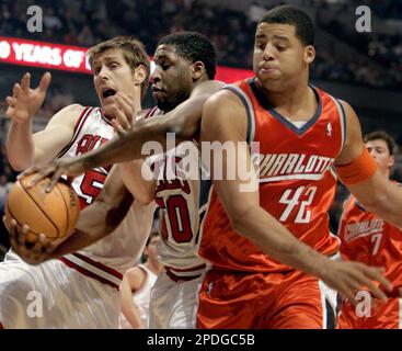 Houston Rockets' Tracy McGrady (1) dunks the ball as Chicago Bulls' Luol  Deng (9), of Sudan, and Chicago Bulls' Andres Nocioni (5), of Argentina,  watch during the first quarter of their NBA