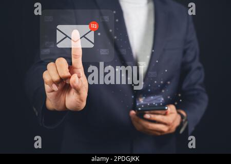 Businessman touching email on virtual screen. electronic message. Email notification concept. Stock Photo