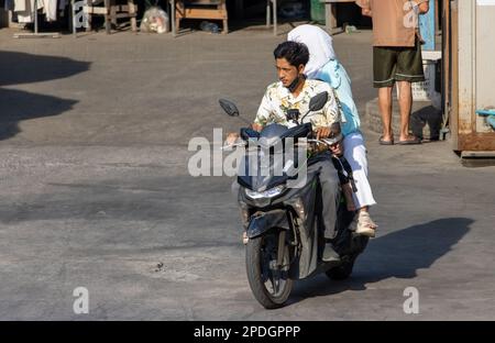 SAMUT PRAKAN, THAILAND, FEB 13 2023, The pair rides on motorcycle at the street. Stock Photo