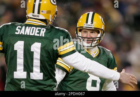 Green Bay Packers holder B.J. Sander watches as kicker Ryan