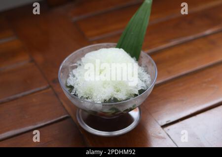 Es Kacang Merah or a cold drink made from red beans boiled with brown sugar served with coconut milk, shaved ice and covered with sweetened condensed Stock Photo