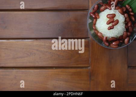 Es Kacang Merah or a cold drink made from red beans boiled with brown sugar served with coconut milk, shaved ice and covered with sweetened condensed Stock Photo