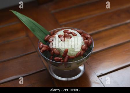 Es Kacang Merah or a cold drink made from red beans boiled with brown sugar served with coconut milk, shaved ice and covered with sweetened condensed Stock Photo