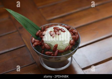 Es Kacang Merah or a cold drink made from red beans boiled with brown sugar served with coconut milk, shaved ice and covered with sweetened condensed Stock Photo