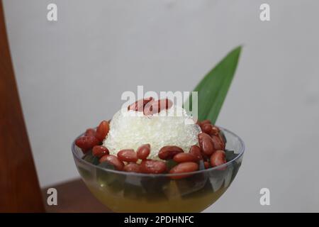 Es Kacang Merah or a cold drink made from red beans boiled with brown sugar served with coconut milk, shaved ice and covered with sweetened condensed Stock Photo