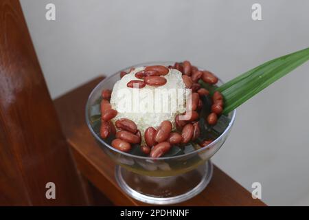 Es Kacang Merah or a cold drink made from red beans boiled with brown sugar served with coconut milk, shaved ice and covered with sweetened condensed Stock Photo