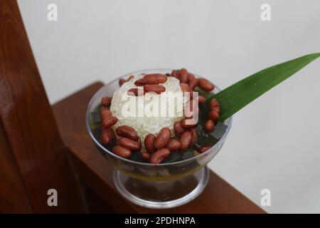 Es Kacang Merah or a cold drink made from red beans boiled with brown sugar served with coconut milk, shaved ice and covered with sweetened condensed Stock Photo