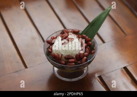 Es Kacang Merah or a cold drink made from red beans boiled with brown sugar served with coconut milk, shaved ice and covered with sweetened condensed Stock Photo