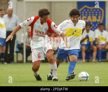 Former Argentina's soccer star Diego Maradona, left, shields the