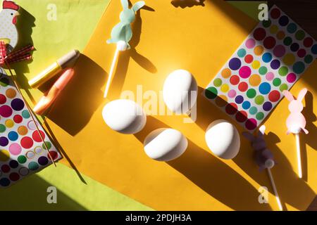 Flat lay composition with chicken eggs, varios decor, Easter holiday. Happy celebration.children's crafts, coloring Easter eggs. Concept creative Stock Photo