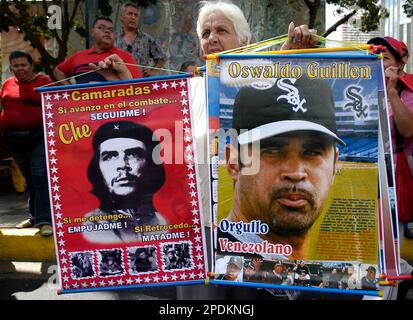 Chicago White Sox manager Oswaldo Ozzie Guillen waves to fans as his wife  Ibis stands behind him at University stadium before a national baseball  league game in Caracas, Venezuela, Friday, Nov. 4