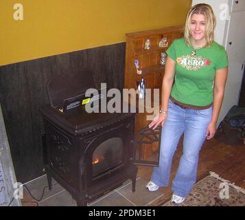 Andrea Marsh stands next to a corn-burning stove at RAM Stoves and  Fireplaces, the business she and her husband, Roger, operate out of their  home in McClure, Pa., Friday, Oct. 21, 2005.