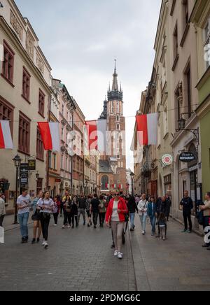 View of tourists in front of  the Town Hall Tower (Wieza Ratuszowa), an Cloth Hall (Sukiennice) at the Main Market Square, center of Old Town ,Krakow Stock Photo