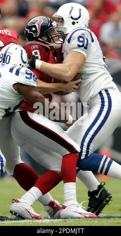 Tampa Bay Buccaneers fullback Mike Alstott (40) is tripped up by  Indianapolis Colts' Raheem Brock (79), while Colts' Montae Reagor (90)  chases during the first quarter Monday night Oct. 6, 2003 in