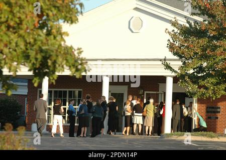 Mourners line up outside Lawrence Free Methodist Church Tuesday