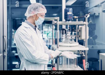 Scientist man working Cannabis CBD oil extraction for medical Science lab. Hemp oil extraction Thin Film Distillation Machine in Laboratory Plants Pro Stock Photo