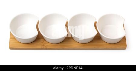 A set of white ceramic tableware on white background. Various types of white plates, bowls and platters, cups, saucers, milkmen. Stock Photo
