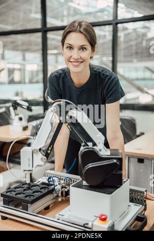 portrait smart woman robot engineer programmer work in robotic lab research and development team. Stock Photo