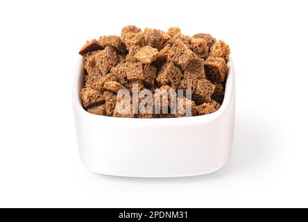 Crispy croutons in bowl isolated on white background with clipping path Stock Photo