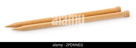 A pair of large wooden knitting needles from low perspective isolated against white background. Stock Photo