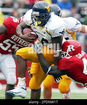 West Virginia's Steve Slaton (10) runs away from East Carolina's