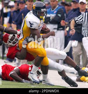 West Virginia's Steve Slaton (10) runs away from East Carolina's