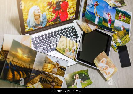 Old family photos on wooden background. Vintage pictures, notepad and modern notebook. Flat lay. Blank photo frames Stock Photo