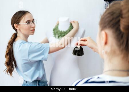 Jewelry small business, jewelry workshop. Two female professional jewelry designers making handmade jewelry in studio workshop. Crafts, fashion Stock Photo
