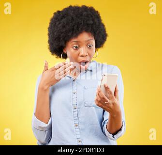 Phone, surprise and shock of black woman in studio isolated on a yellow  background. Wow, cellphone and surprised African female with smartphone for  Stock Photo - Alamy