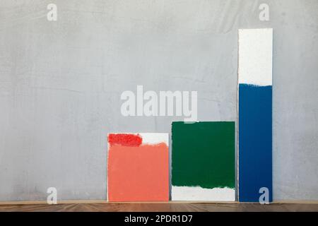 Red green and blue color samplers at blank gypsum plaster wall. Choosing wall paint color during house renovation Stock Photo