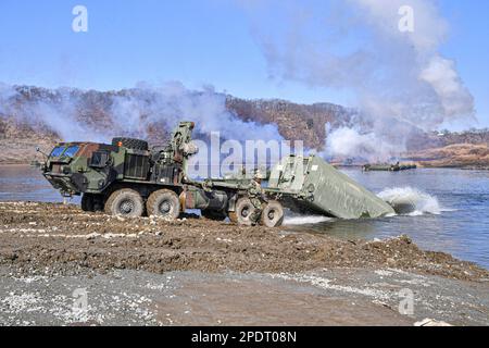 March 13, 2023, YEONCHEON, GYEONGGI, SOUTH KOREA: March 15, 2023-Yeoncheon, South Korea-Military vehicles cross a makeshift bridge assembled by South Korean and U.S. troops during combined river-crossing drills at a training ground in the border county of Yeoncheon, 62 kilometers of Seoul, in this photo provided by the South's Army on March 15, 2023. The drills kicked off on March 6 and will run until March 17. South Korea and the United States are conducting combined river-crossing military drills in a border county, the Army here said Wednesday, as part of the allies' ongoing springtime exer Stock Photo