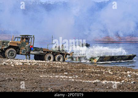 March 13, 2023, YEONCHEON, GYEONGGI, SOUTH KOREA: March 15, 2023-Yeoncheon, South Korea-Military vehicles cross a makeshift bridge assembled by South Korean and U.S. troops during combined river-crossing drills at a training ground in the border county of Yeoncheon, 62 kilometers of Seoul, in this photo provided by the South's Army on March 15, 2023. The drills kicked off on March 6 and will run until March 17. South Korea and the United States are conducting combined river-crossing military drills in a border county, the Army here said Wednesday, as part of the allies' ongoing springtime exer Stock Photo