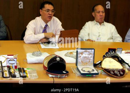 Ricardo Ebcede, left, a commissioner of the Presidential Commission on Good  Government (PCGG) shows to the media an array of former Philippine First  Lady Imelda Marcos' seized jewelry at the Central Bank in Manila Thursday  Sept. 15, 2005. The PCGG
