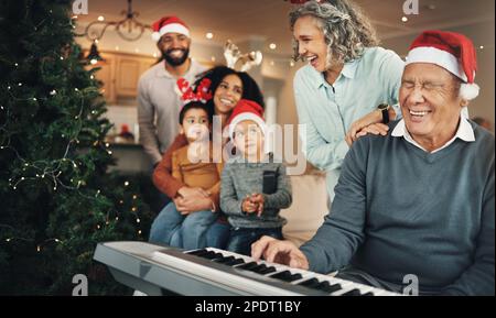 Christmas, happy family and senior man on piano in living room for celebration, song and bond in their home. Music, instrument and retired pianist Stock Photo