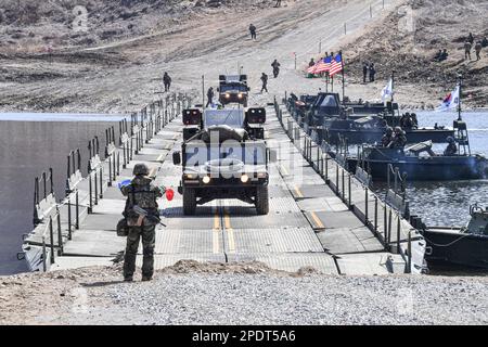 March 13, 2023, YEONCHEON, GYEONGGI, SOUTH KOREA: March 15, 2023-Yeoncheon, South Korea-Military vehicles cross a makeshift bridge assembled by South Korean and U.S. troops during combined river-crossing drills at a training ground in the border county of Yeoncheon, 62 kilometers of Seoul, in this photo provided by the South's Army on March 15, 2023. The drills kicked off on March 6 and will run until March 17. South Korea and the United States are conducting combined river-crossing military drills in a border county, the Army here said Wednesday, as part of the allies' ongoing springtime exer Stock Photo