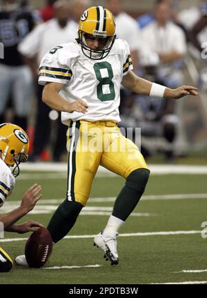 Green Bay Packers holder B.J. Sander watches as kicker Ryan