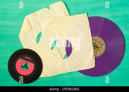 Old grungy vinyl records with blank torn sleeve and blank label, free copy space, isolated on white. Stock Photo