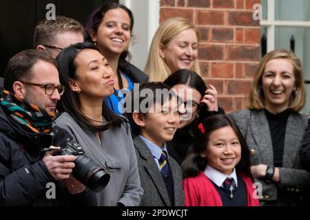 Lucy Hunt, second left the wife of Britain's Chancellor of the Exchequer Jeremy Hunt with two of her children watch as he leaves 11 Downing Street for the House of Commons to deliver the Budget In London, Wednesday, March 15, 2023. (AP Photo/Frank Augstein)