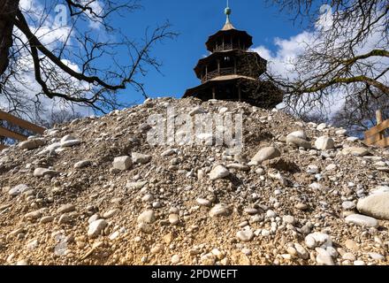 Munich, Germany. 15th Mar, 2023. A pile of rubble rises into the blue sky in front of the Chinese Tower at the beer garden in the English Garden. Credit: Peter Kneffel/dpa/Alamy Live News Stock Photo