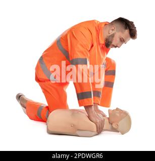 Paramedic in uniform practicing first aid on mannequin against white background Stock Photo