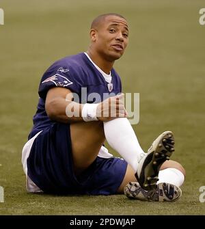 New England Patriots safety Rodney Harrison is dressed for the cold as he  stands on the stadium field as practice begins at the NFL football team's  facility in Foxborough, Mass., Thursday afternoon