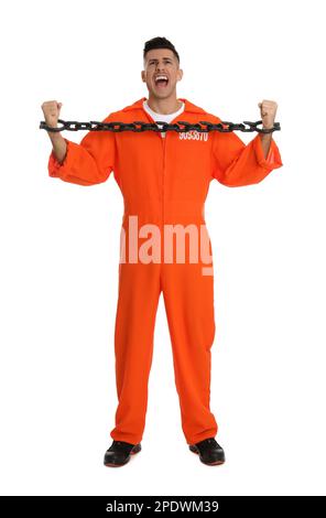 Emotional prisoner in orange jumpsuit with chained hands on white background Stock Photo