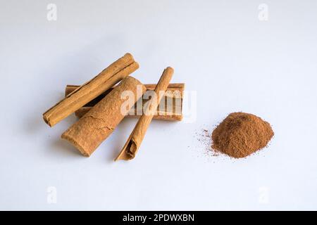 Cinnamon sticks and powder. Isolated on white background. Stock Photo