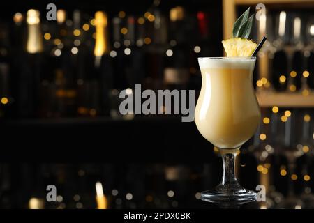 Tasty Pina Colada cocktail on bar countertop, space for text Stock Photo