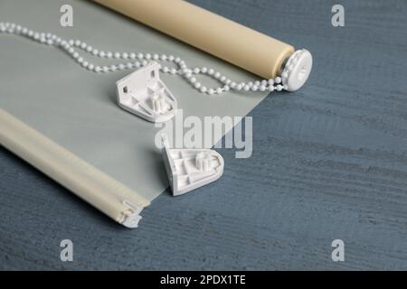 Stylish roller window blinds and details on grey wooden table, space for text Stock Photo