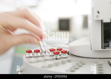 Small medical bottles in centrifuge, close-up Stock Photo